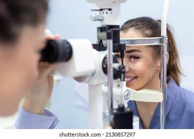 Female Doctor Ophthalmologist Is Checking The Eye Vision Of Attractive Young Woman In Modern Clinic. Doctor And Patient In Ophthalmology Clinic