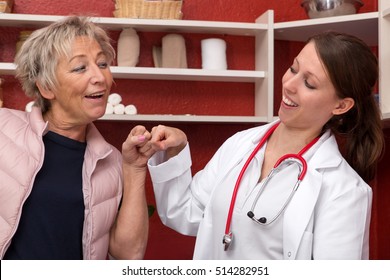 Female Doctor And Patient Making A Bro Greeting In The Office