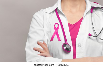 Female Doctor With Pink Ribbon. Cancer Concept