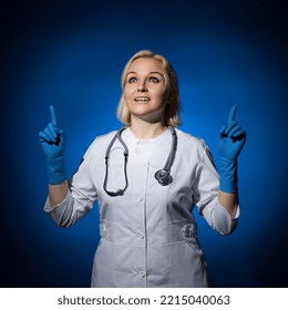 Female Doctor Points Fingers Up. Ascension Concept