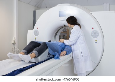 Female Doctor Preparing Patient For CT Scan