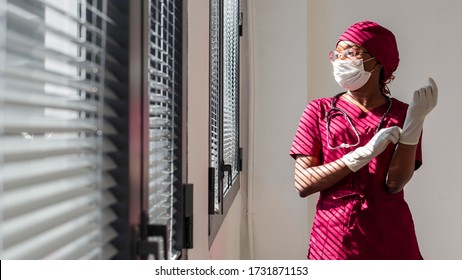 Female doctor putting her gloves. Black health professional, afro american doctor, african nurse. - Powered by Shutterstock