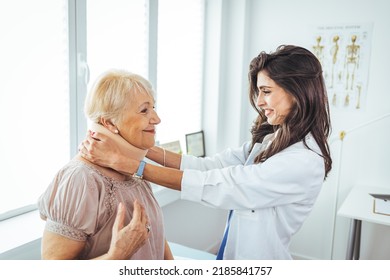 Female Doctor Putting Neck Orthopaedic Collar On Adult Injured Woman. Woman In Pain At The Doctor For A Neck Injury. Doctor Giving A Prescription To A Senior Patient With Cervical Collar