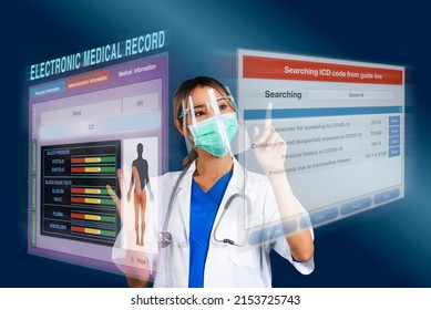 Female doctor searching disease code while work on electronic medical record that display as holographic images on blue background.