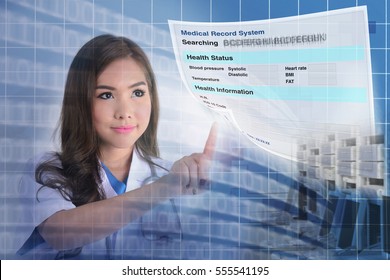 Female Doctor Searching Patient Information From Electronic Medical Record System. 