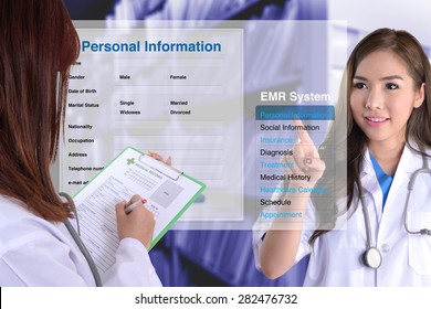 Female Doctor Show How To Use Electronic Medical Record While Another One Checking Patient Information By Hand.