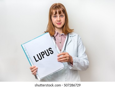 Female Doctor Showing Medical Clipboard With Written Text: Lupus