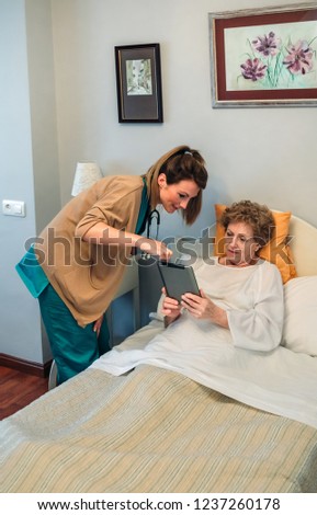 Similar – Caregiver helping elderly female patient to get out of bed