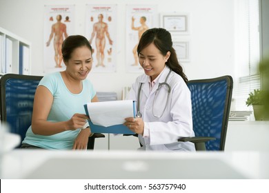 Female Doctor Showing Test Results To Patient