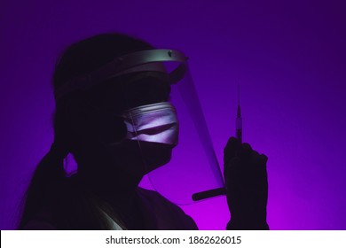 Female Doctor Silhouette Holding A Vaccine In Hand