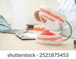  A female doctor sits at a table in a hospital, discussing dental issues like wisdom teeth, cavities, dentures,missing teeth, and cracked teeth, explaining the causes and treatment of dental caries.