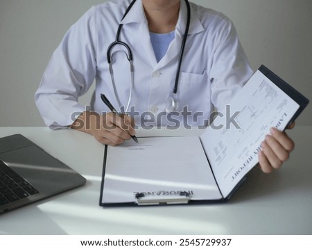 Similar – Doctor giving a prescription to senior patient