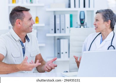 Female doctor speaking with her patient in medical office