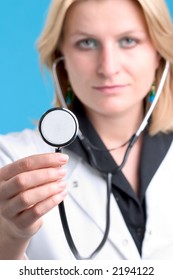 Female Doctor With Stethoscope, Portrait. Shallow Depth Of Field With Focus On The Stethoscope.