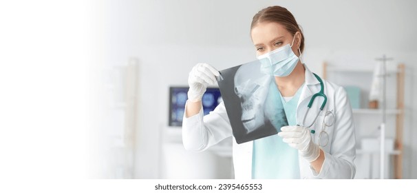 Female doctor studying x-ray image of skull in clinic. Banner for design - Shutterstock ID 2395465553