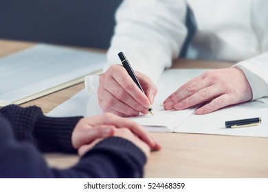 Female Doctor Taking Notes During Patient's Medical Exam, Writing Medical History Record For The Woman