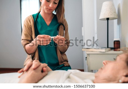 Similar – Female doctor giving medication to elderly patient