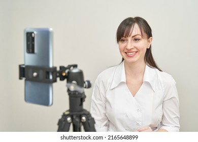 Female Doctor Talk To Patient By Phone. Telemedicine Content. Tripod Hold Camera. Blogger Therapist. Telehealth Media Record. Internet Clinic Speech. Hospital Webinar Office