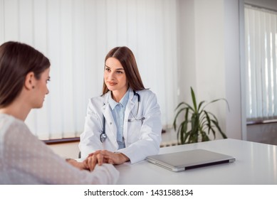 Female Doctor Talking With Concerned Patient.