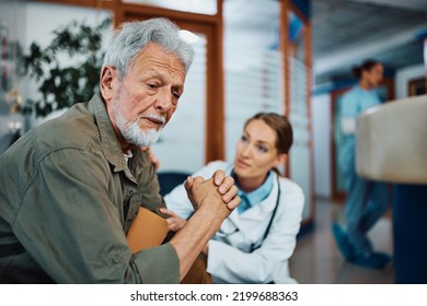 Female doctor talking to distraught mature man in waiting room in the hospital. Focus is on man.  - Powered by Shutterstock