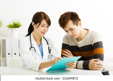 Female Doctor Talking With  Patient In  Office