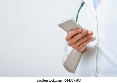 A Female Doctor Texting On Smartphone In Medical Office