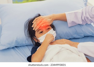 Female doctor touching forehead attentive treating influenza symptoms young girl who is sick weak infected with virus wearing medical mask treating the sick hospital bed hospital treatment room.  - Powered by Shutterstock