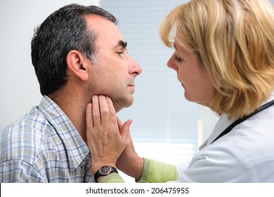 female doctor touching the throat of a patient in the office