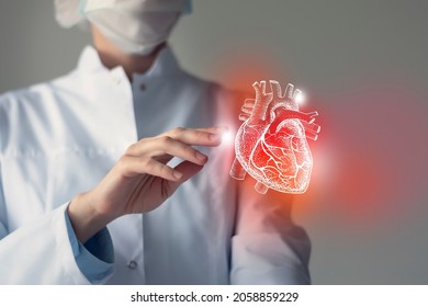 Female doctor touchstone virtual Heart in hand. Blurred photo, handrawn human organ, highlighted red as symbol of disease. Healthcare hospital service concept stock photo - Shutterstock ID 2058859229