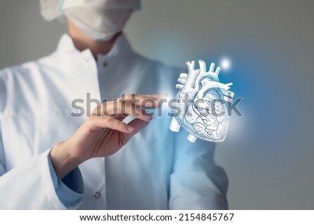 Female doctor touchstone virtual Heart in hand. Blurred photo, handrawn human organ, highlighted blue as symbol of recovery. Healthcare hospital service concept stock photo