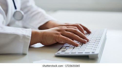 Female Doctor Typing With Her Keyboard In Medical Office