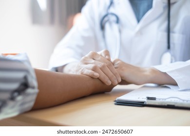 The female doctor uses a friendly hand to hold the patient's hand to give confidence and show care about health care. Medical concepts and good health. - Powered by Shutterstock