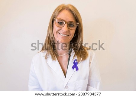 Female doctor using breast cancer awareness ribbon.