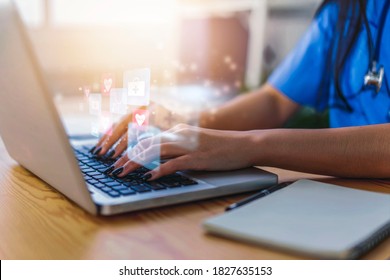 Female Doctor Using A Computer Laptop Working Using Modern Technology Diagnosing Patient Health Researching Information, Medical Healthcare Medicine Worker With Graphical Icon, In Hospital Work Office