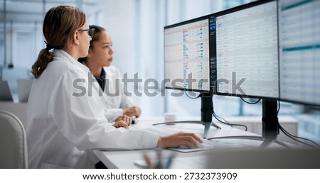 Female Doctor Using Computer Screen To Manage Hospital Billing Process.