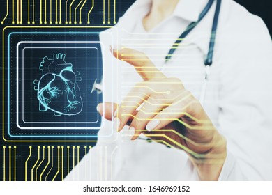 Female doctor using creative glowing digital heart futuristic interface hologram. Medicine, cardiology and future concept.
