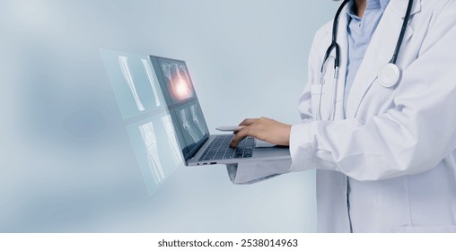 Female doctor using digital laptop and looking x-ray films, Medical and healthcare concept. - Powered by Shutterstock