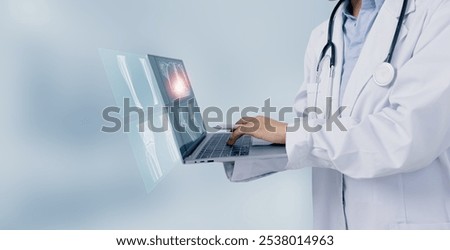 Female doctor using digital laptop and looking x-ray films, Medical and healthcare concept.