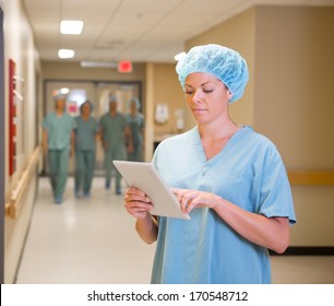 Female doctor using digital tablet in hospital corridor - Powered by Shutterstock