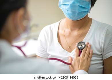 Female doctor using stethoscope exam Asian female patient for physical examine pneumonia lung sound checkup in hospital. Coronavirus, covid-19, medical and healthcare concept - Shutterstock ID 2105414033