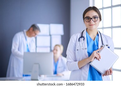 Female doctor using tablet computer in hospital lobby
