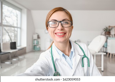 Female Doctor Using Video Chat In Clinic