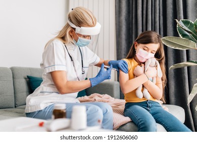 Female Doctor Vaccinating Child Patient At Home. Coronavirus, Covid-19 Concept.