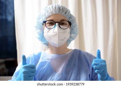 Female doctor in vaccination center or hospital is in a good mood and gives a thumbs up, awaiting patients for Corona vaccination