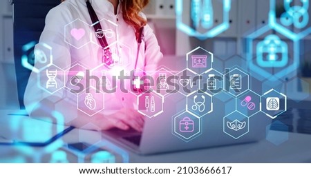Female doctor wearing white suit is working and typing on laptop. Digital interface with icons of dna, syringe, pills, mask, heart, thermometer in foreground. Concept of heath care and diagnostics
