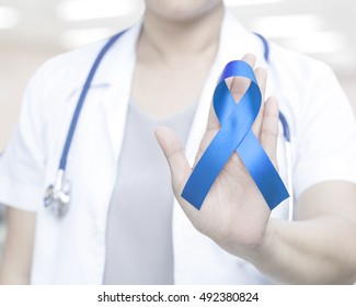 Female Doctor In White Uniform With Blue Ribbon Awareness In Hand For Addiction Recovery Awareness,Alopecia ,Acute Respiratory Distress Syndrome (ARDS), Apraxia, Arthritis Awareness An Beat Bullying. 