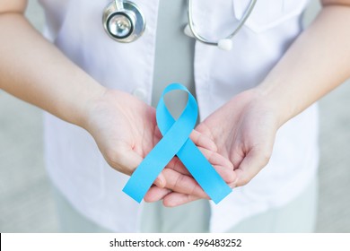 Female doctor in white uniform hold light blue ribbon awareness in hand for Addisons Disease,Behcets Disease,Chronic Illness,Hyperaldosteronism,Lymphedema,Men's Health,Prostate cancer,Thyroid Disease