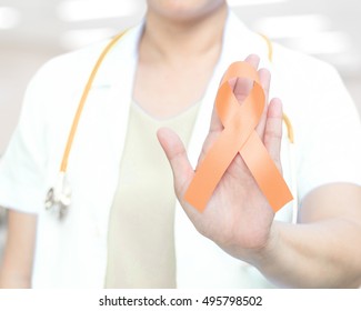 Female doctor in white uniform with peach ribbon awareness in hand as stop sign for Endometrial Cancer, Uterine Cancer, Vaginal Cancer. Medical healthcare concept - Powered by Shutterstock