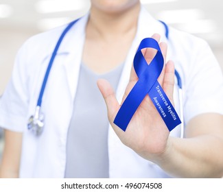 Female Doctor In White Uniform With Royal Blue Ribbon Awareness In Hand As Stop Sign For Transverse Myelitis Awareness , Healthcare, Medical Concept.