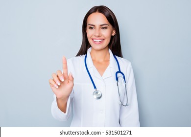 Female Doctor In White Uniform Touching Virtual Screen